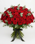 Luxurious dome-shaped bouquet of deep red roses with eucalyptus foliage, finished with elegant black Amarante London ribbon - premium Valentine's Day arrangement showcasing approximately 150 fresh roses in sophisticated hand-tied style - Amaranté London