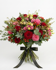 Luxury Aurora Valentine's bouquet featuring deep red roses, bright pink roses, soft pink lisianthus, delicate waxflower sprigs, and eucalyptus foliage tied with elegant black Amarante London ribbon - Amaranté London