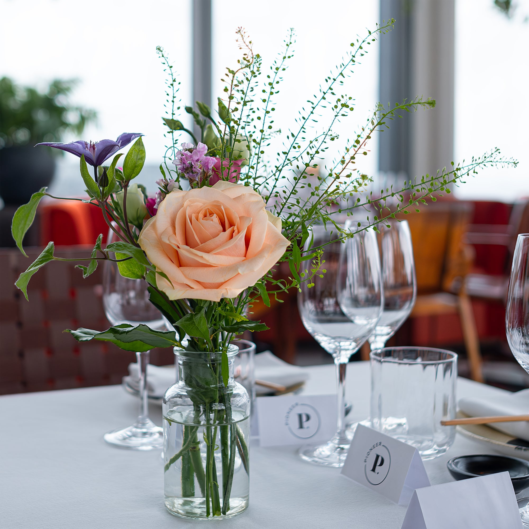 A close-up of a sophisticated floral arrangement at the Chanel event in SUSHISAMBA. This elegant arrangement by Amaranté London includes pastel roses and delicate greenery, creating a refined and professional look for this exclusive corporate event.