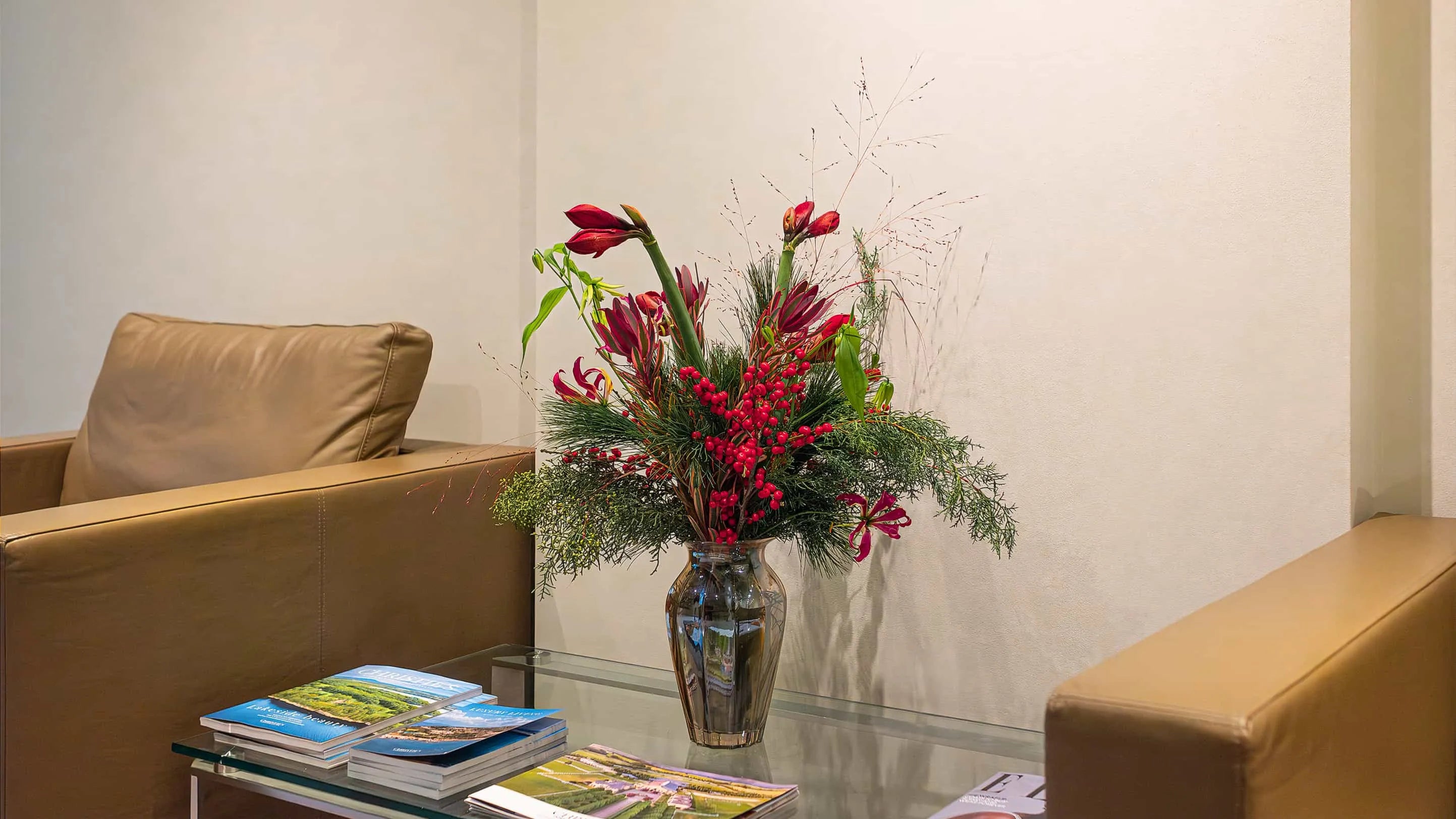 Christmas Bouquet in transparent glass vase on coffee table at Christie's designed and created by Amaranté London 