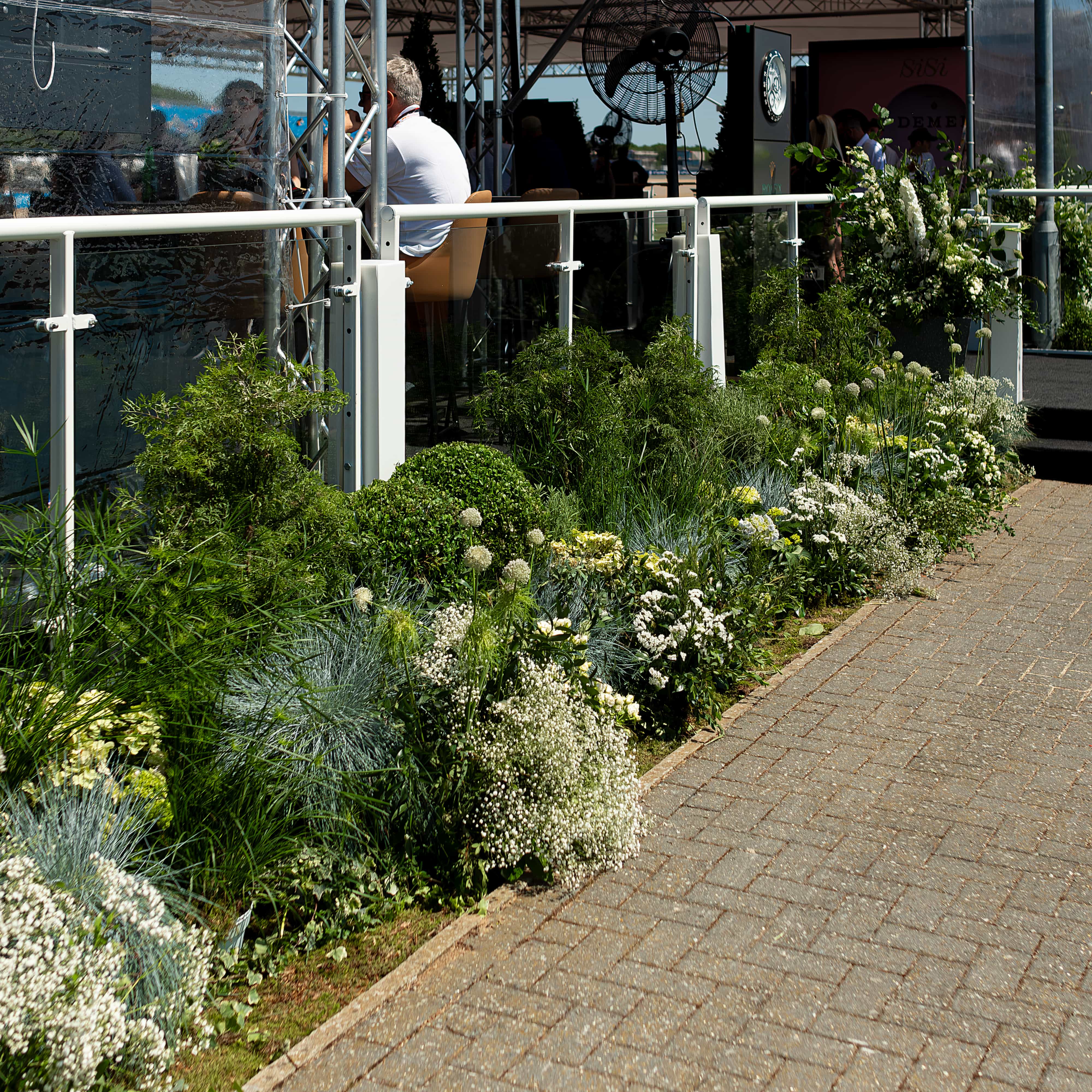 Exquisitely curated plant installations, meticulously arranged, elevating the ambiance at Formula 1's racing event held at Silverstone.