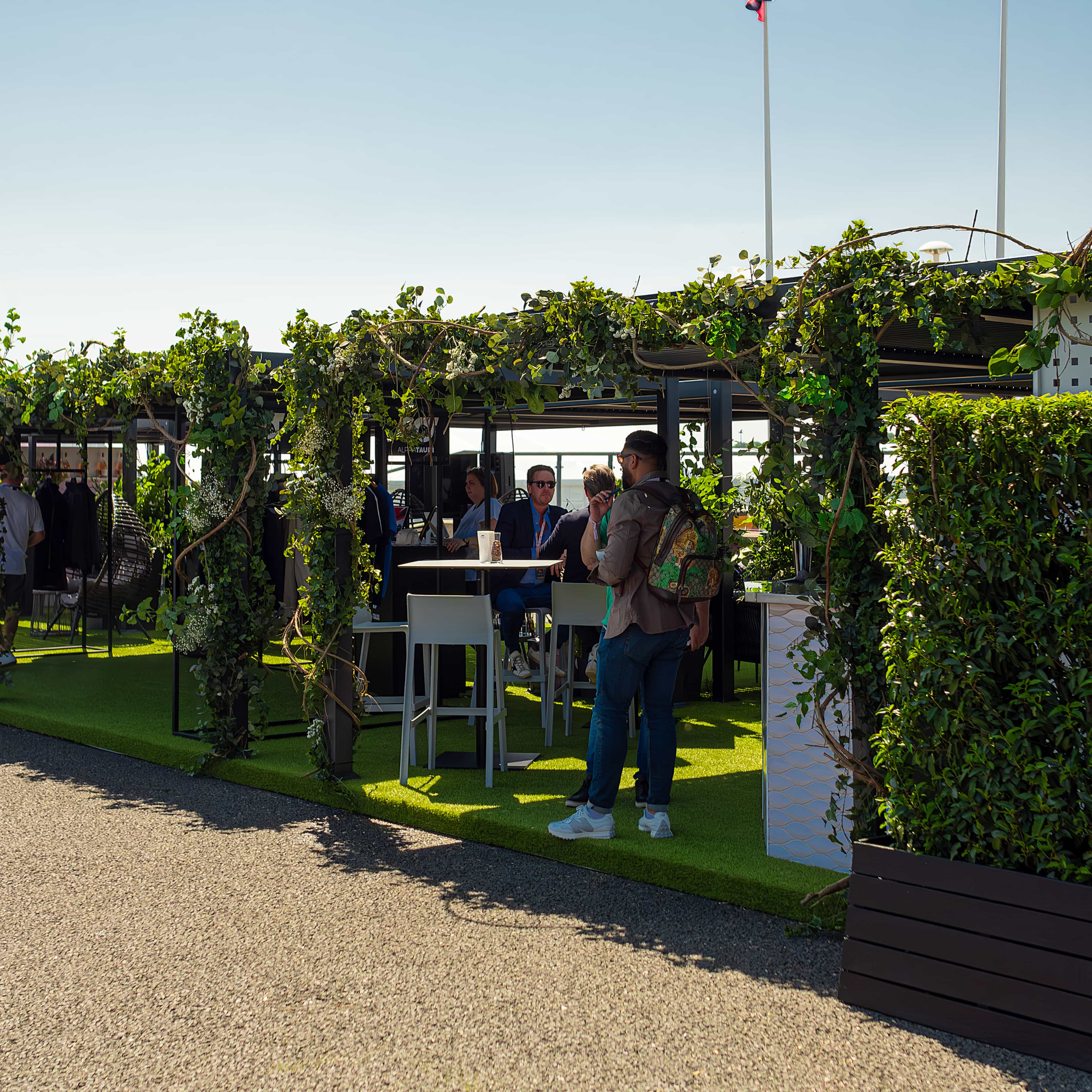 Captivating verdant archways gracing the Formula 1 Paddock, elevated by the nature-inspired decor crafted by event florist Amaranté.