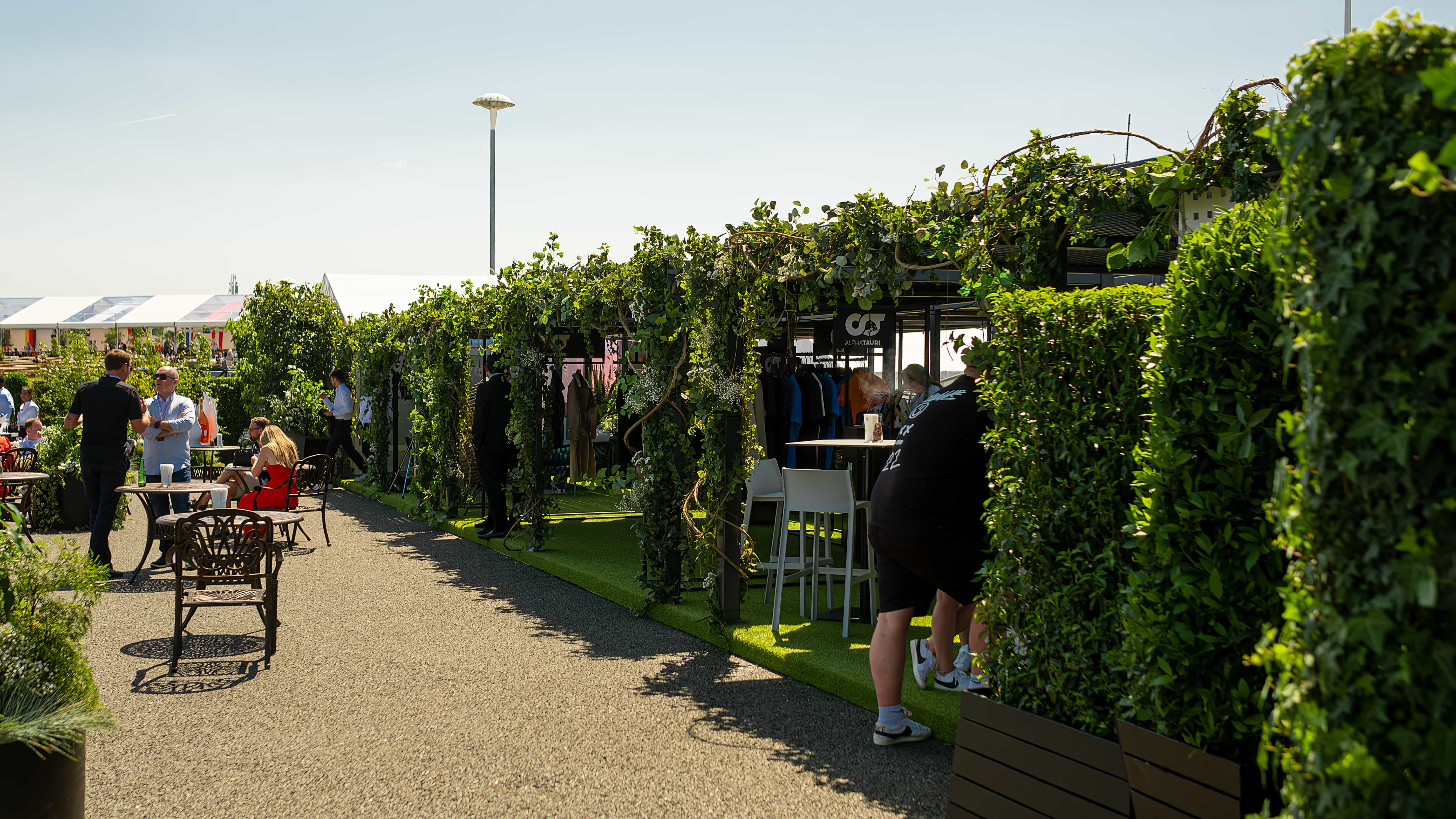 Enchanting natural green arches at Formula 1 Paddock area, enhanced by event florist Amaranté's nature-inspired decor.