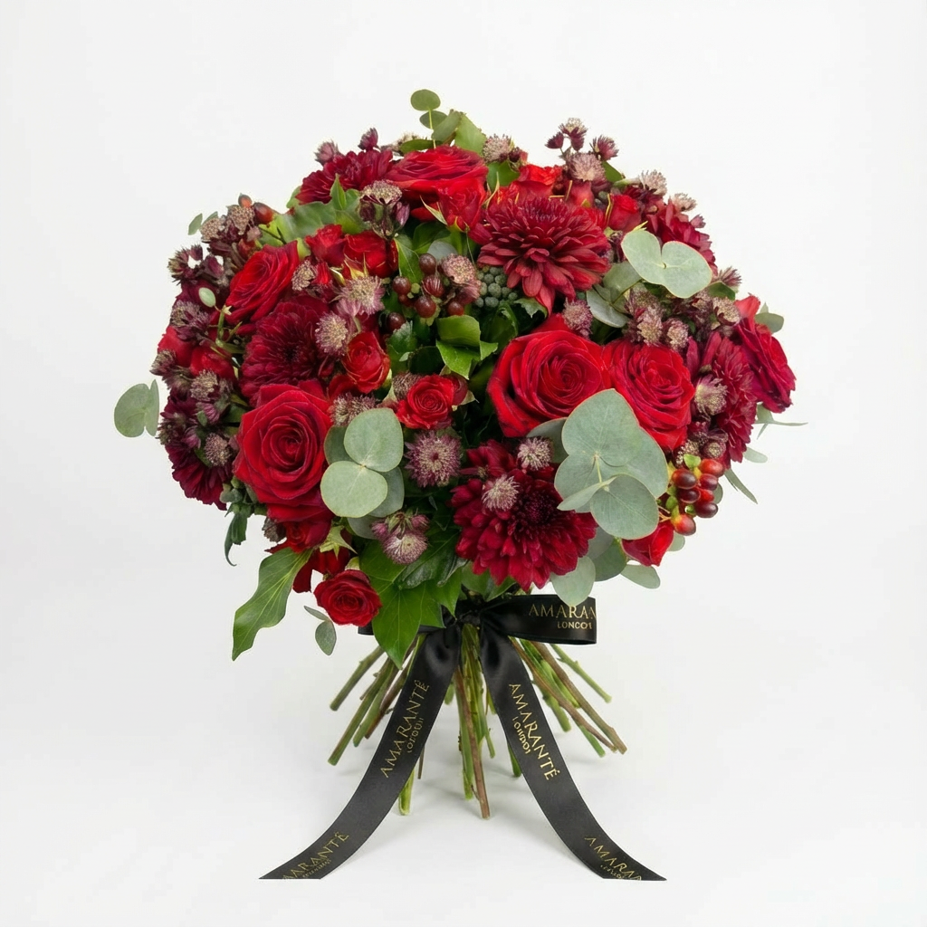 Luxurious Valentine's Day bouquet featuring vibrant red roses, burgundy dahlias, and burgundy astrantia with eucalyptus foliage, tied with elegant black Amarante London ribbon - Amaranté London