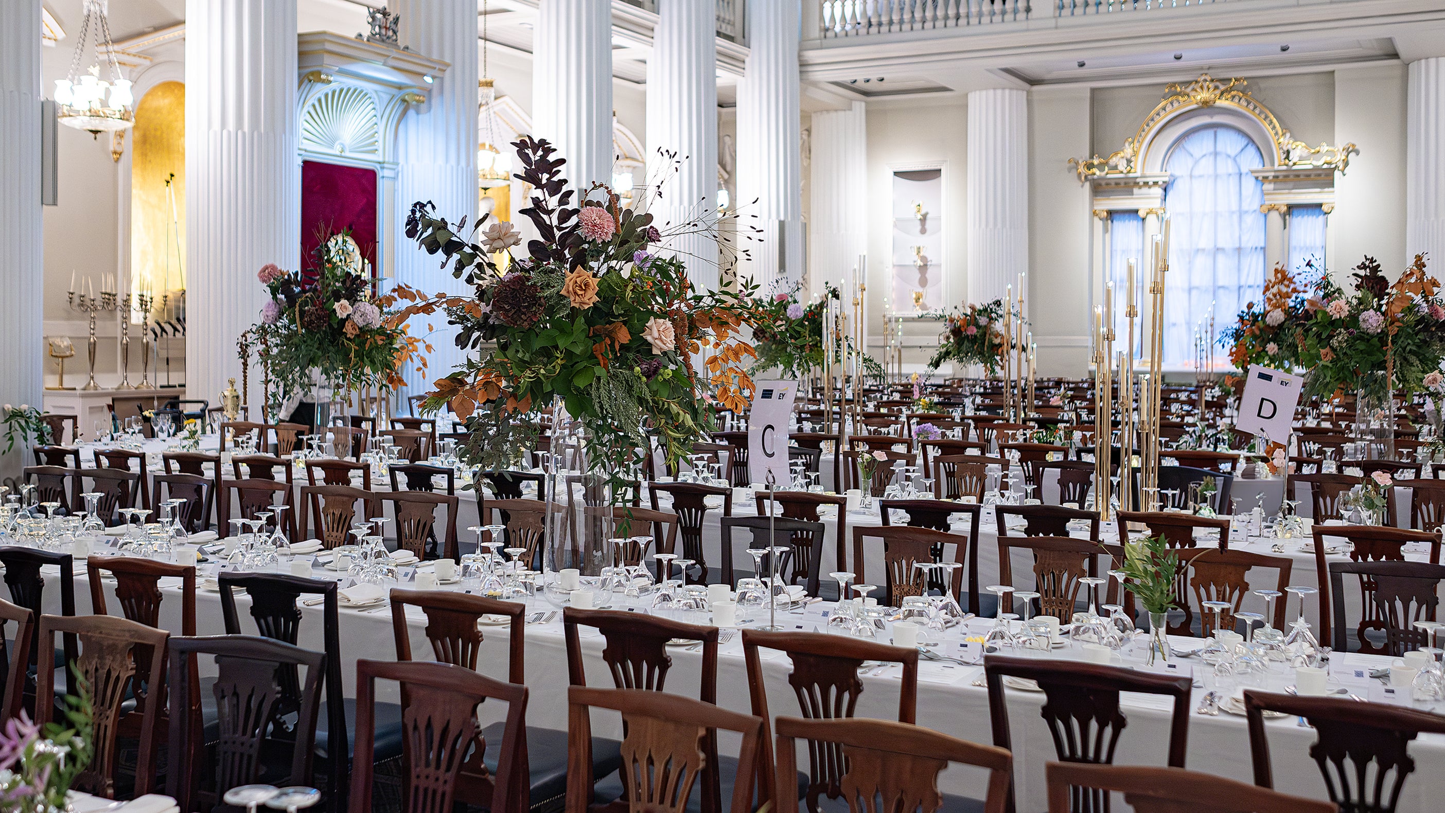 Elegant long tables adorned with exquisite floral arrangements