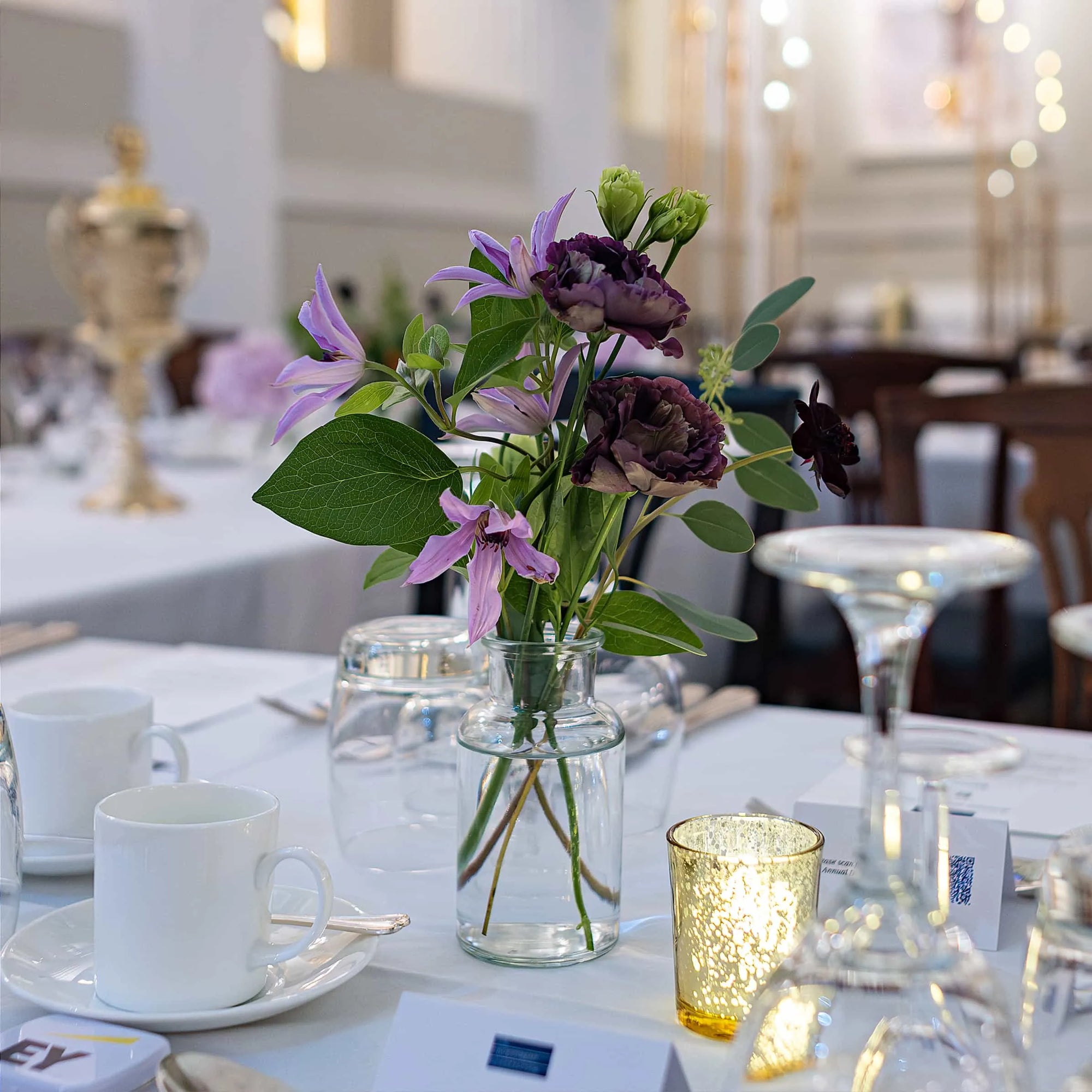 Delicate single floral arrangement in a charming centrepiece jar