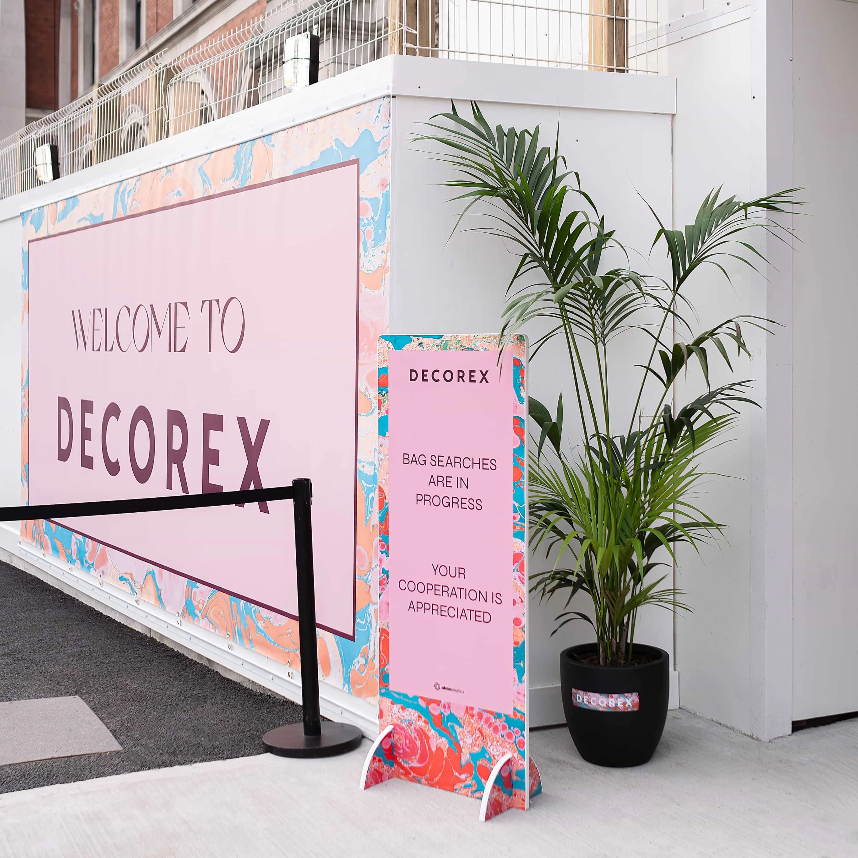 Decorex entrance signage complemented by elegant plant arrangements, enhancing the event's welcoming atmosphere with a touch of greenery Plant Hire Services by Amaranté London