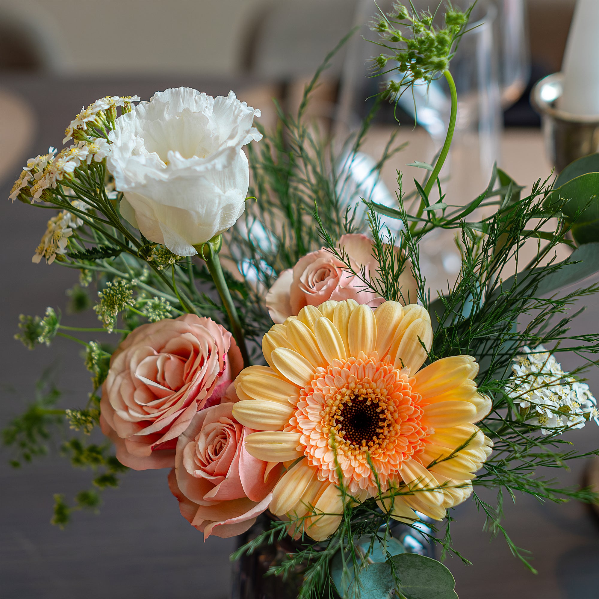 Vibrant and elegant bespoke floral arrangements by Amaranté London for the Pan Pacific luxury 5-star hotel in London. This bouquet features a mix of roses, gerbera daisies, and lush greenery, designed to enhance the table setting with a touch of luxury and sophistication in this corporate event setting.