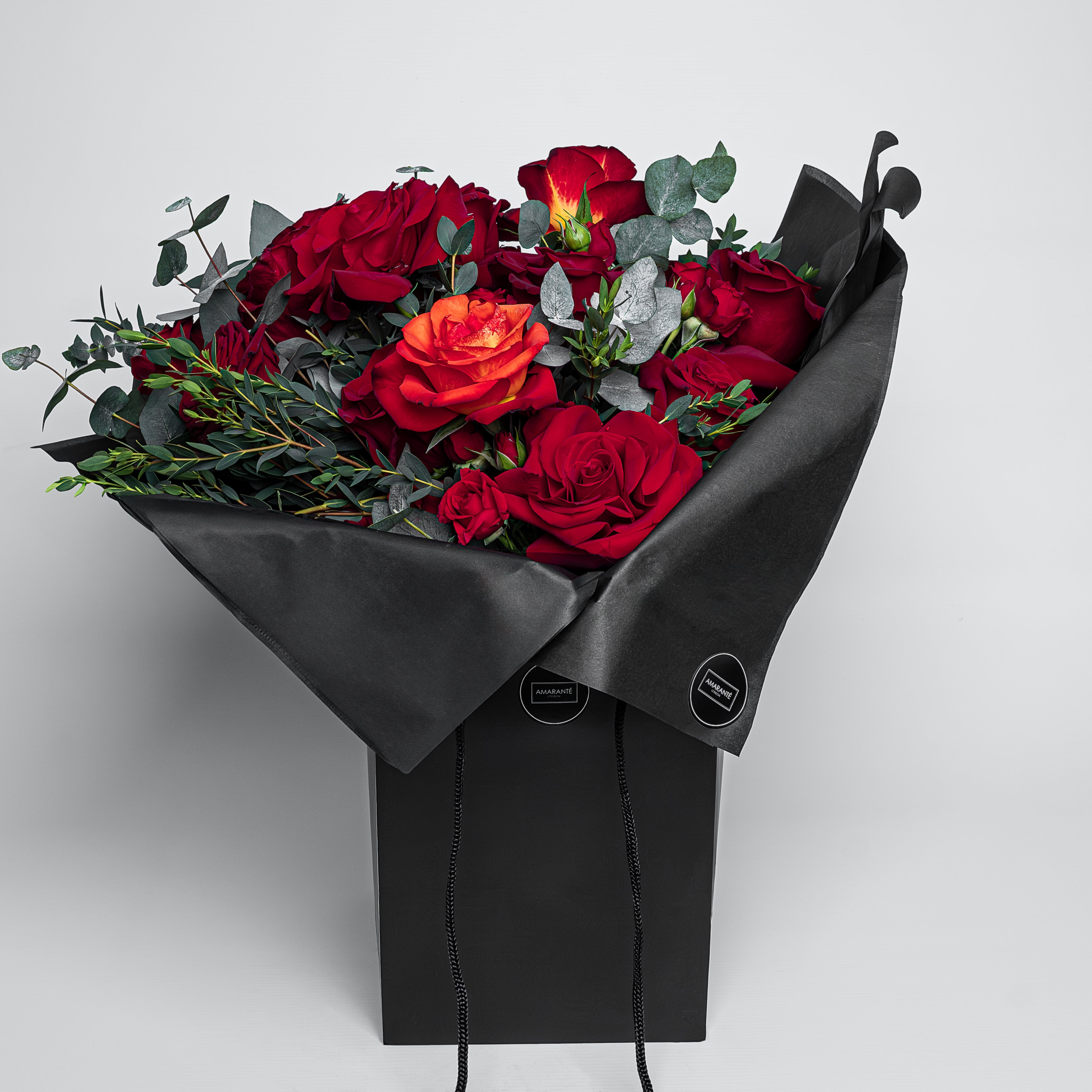 An exquisite Valentine&#39;s Day Bouquet of fresh roses in an elegant black gift box from Amarante London. The luxurious bouquet of red roses is a sophisticated and beautifully arranged bouquet, for a timeless expression of love and affection. The stems display a polished and refined green, adding to the bouquet&#39;s elegance, perfect for Vday - Free UK Delivery. Celebrate Valentine&#39;s with this elegant, graceful fresh flower arrangement!