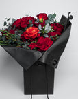 An exquisite Valentine's Day Bouquet of fresh roses in an elegant black gift box from Amarante London. The luxurious bouquet of red roses is a sophisticated and beautifully arranged bouquet, for a timeless expression of love and affection. The stems display a polished and refined green, adding to the bouquet's elegance, perfect for Vday - Free UK Delivery. Celebrate Valentine's with this elegant, graceful fresh flower arrangement!