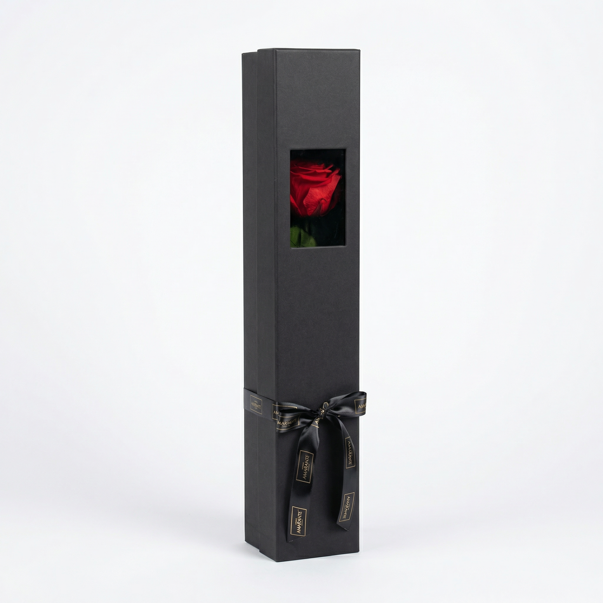 Elegant charcoal grey luxury gift box with rectangular window revealing single preserved red rose, finished with sophisticated black ribbon and branded tags - Amarante London
