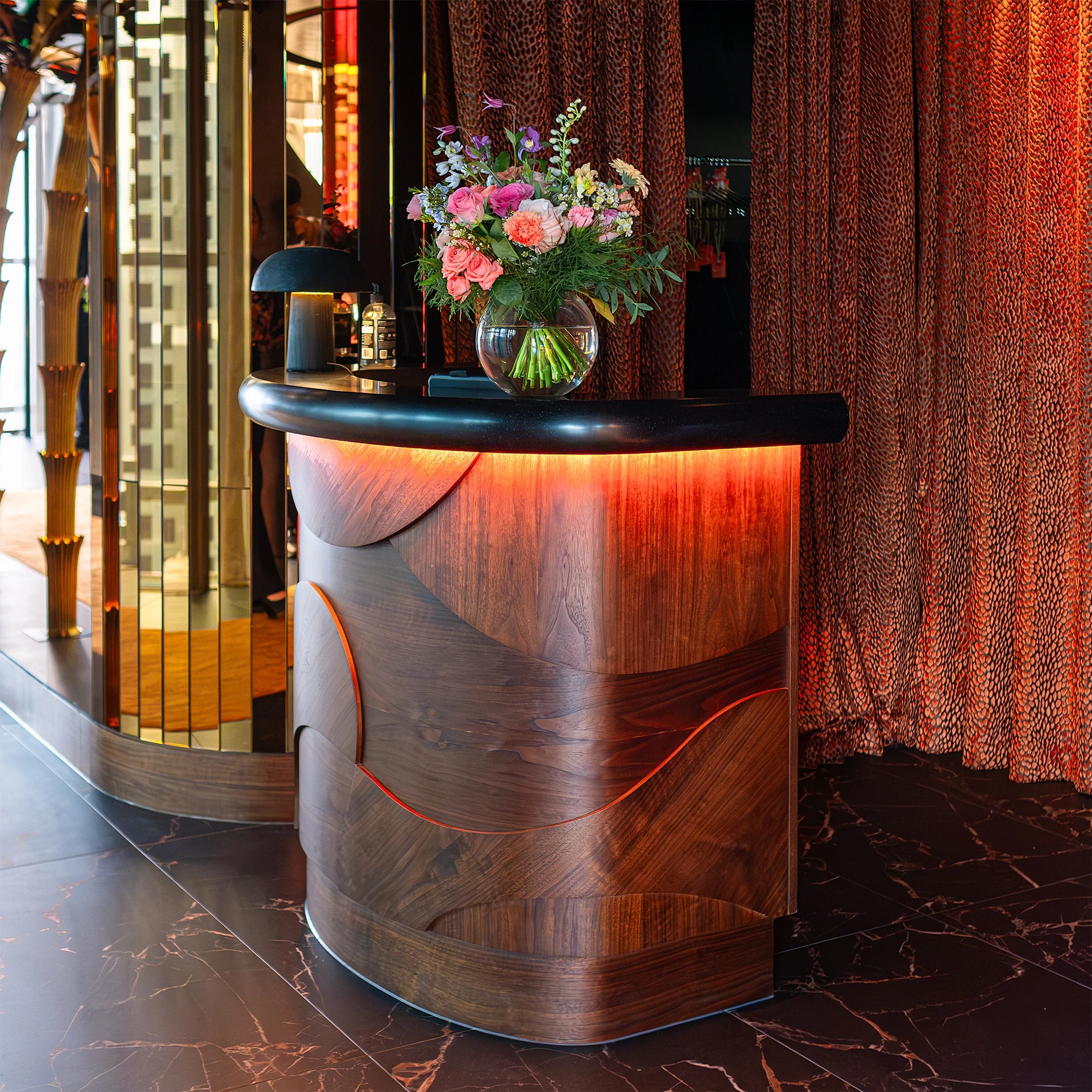A beautiful bespoke floral party decoration by Amarante London at Sushi Samba features a mix of blue hydrangeas, peach roses, and vibrant greenery, adding a luxurious touch to the birthday event décor.