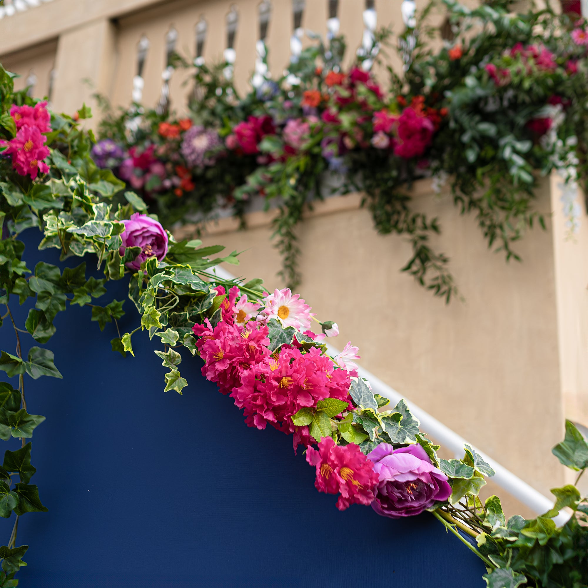 This is a photo of a Hanging floral installation designed for the Angelo Poretti stand at Regent’s Park Taste Festival. It features cascading green foliage and pink, orange, and white flowers designed, created, and installed by Amaranté London. The arrangement adds vertical interest and elegance, enhancing the Mediterranean theme of this Italian Beer manufacturer.