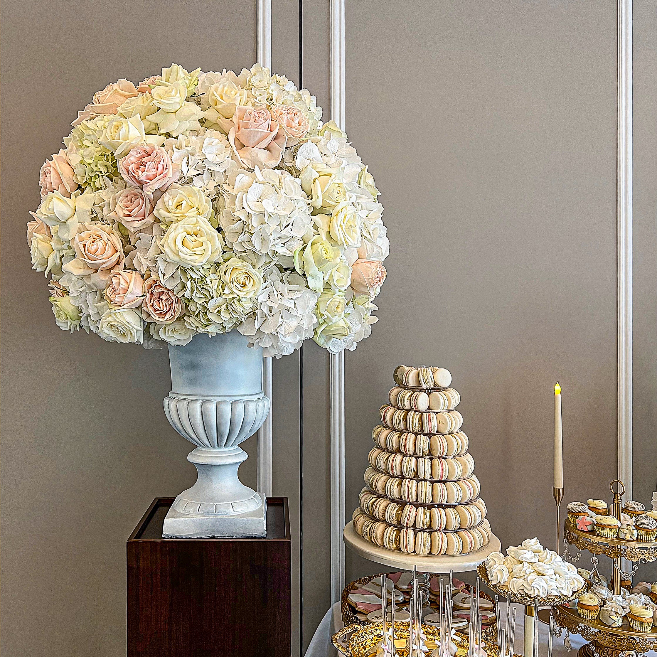 Classical floral arrangement featuring neutral roses and hydrangeas in ivory and blush tones, complementing an elegant dessert display - Amaranté London Event Florist