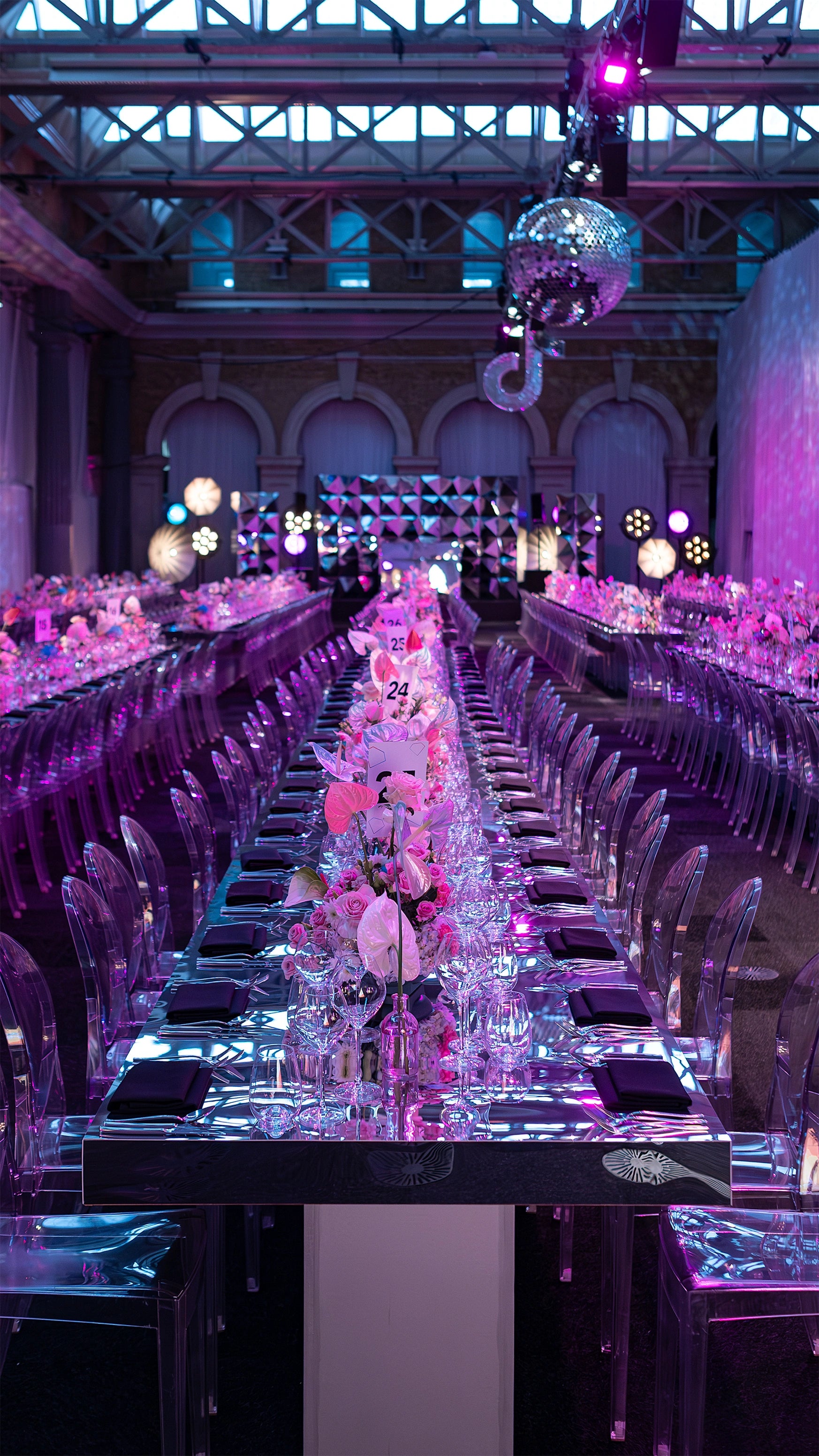 TikTok Event, elegant tablescape featuring pink orchid centerpieces with crystal glassware and ambient lighting in a grand venue setting - Floral Design by Amaranté London