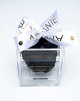 Black single rose in a transparent acrylic box decorated with a white ribbon - a unique symbol of love and affection to celebrate Valentine's Day and other memorable romantic events.