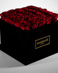 Magical red Roses featured in a stylish large square suede box 