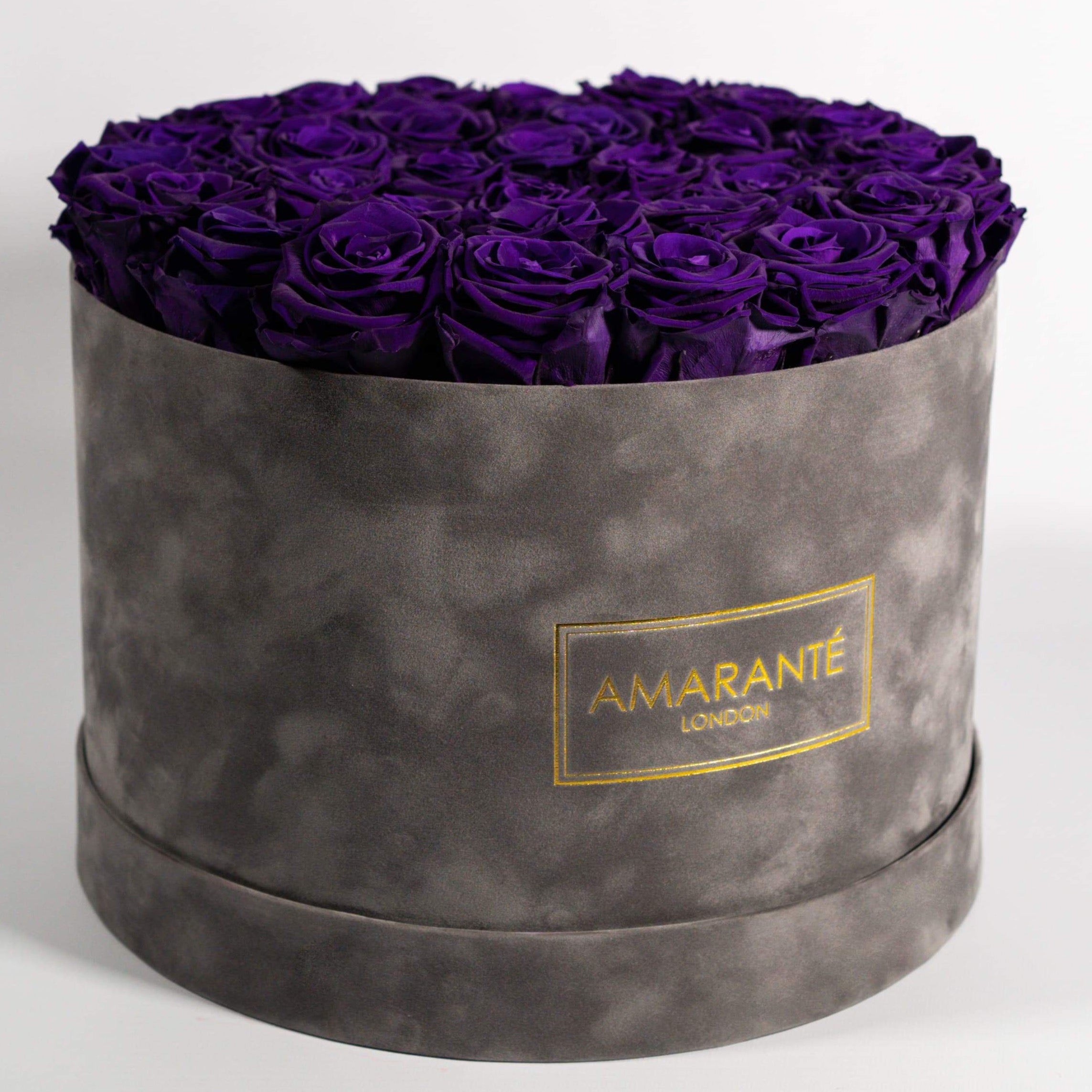 Cherished dark purple Roses in a dapper grey box, expressing luxury and magic. 
