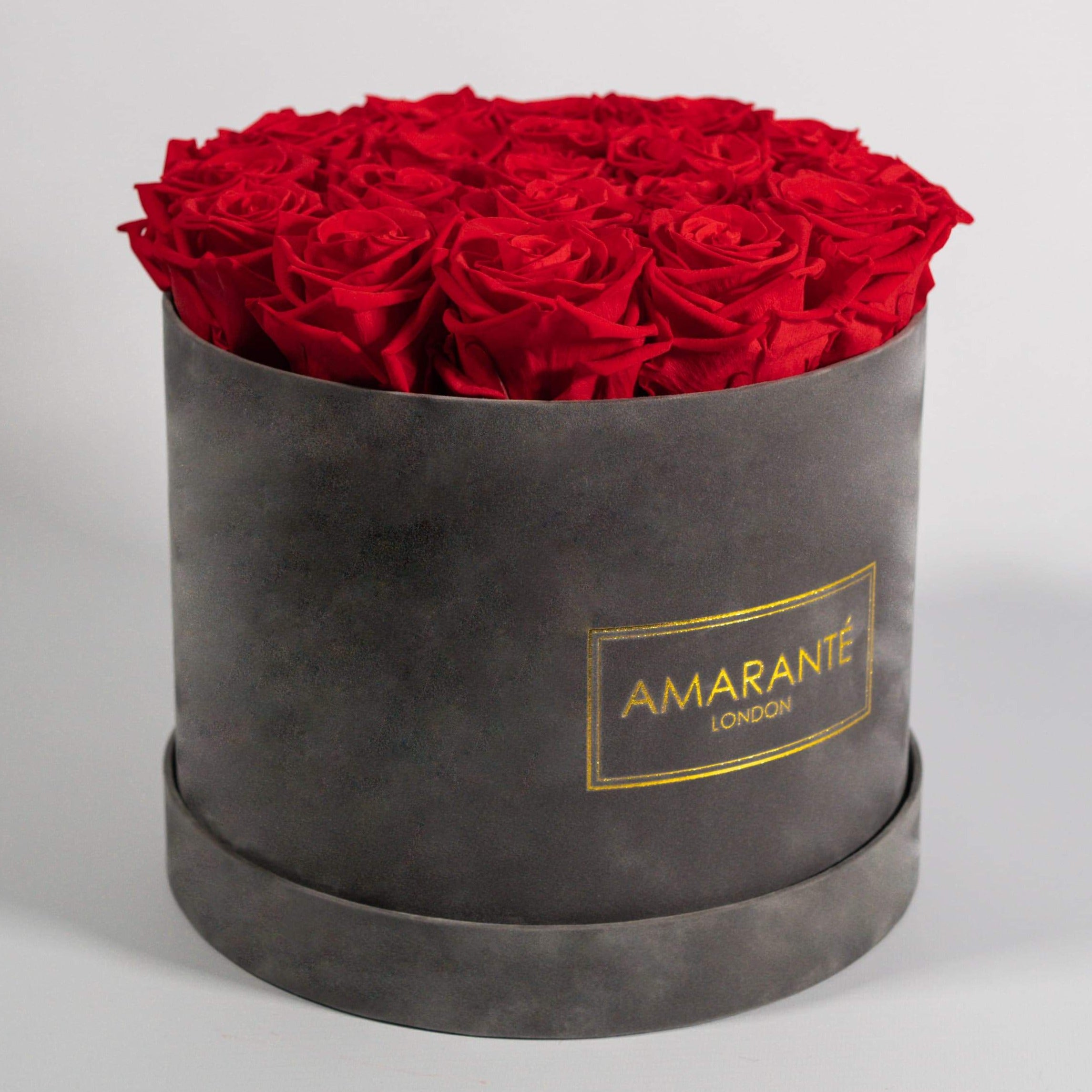 Divine red Roses in a dapper grey box, bursting with fiery colours