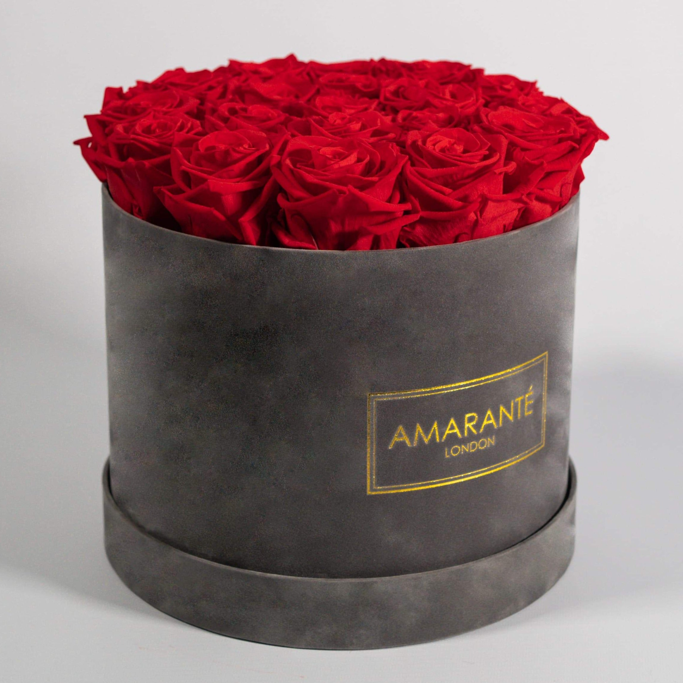 Divine red Roses in a dapper grey box, bursting with fiery colours