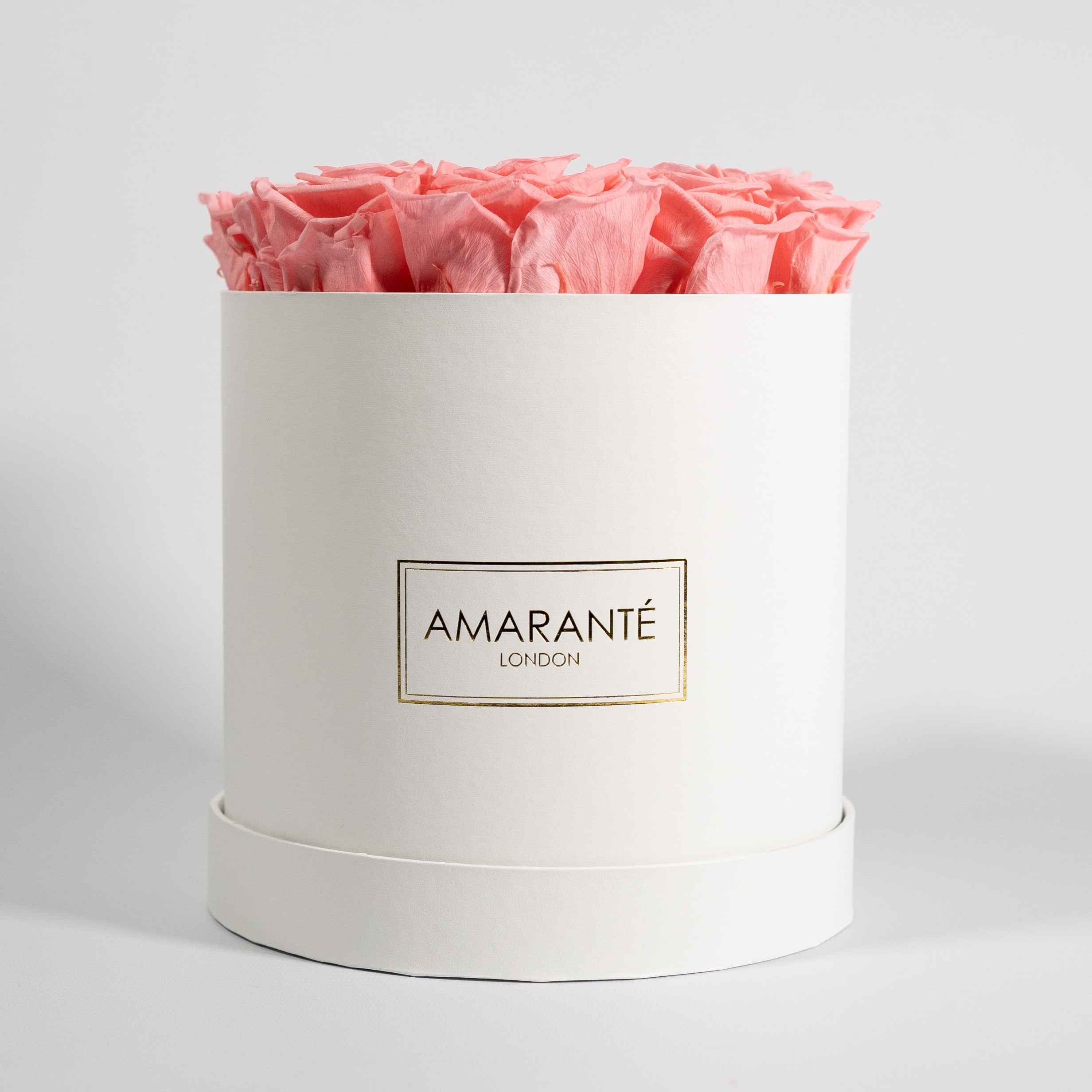 Delicate light pink Roses encompassed in a beautiful white box 