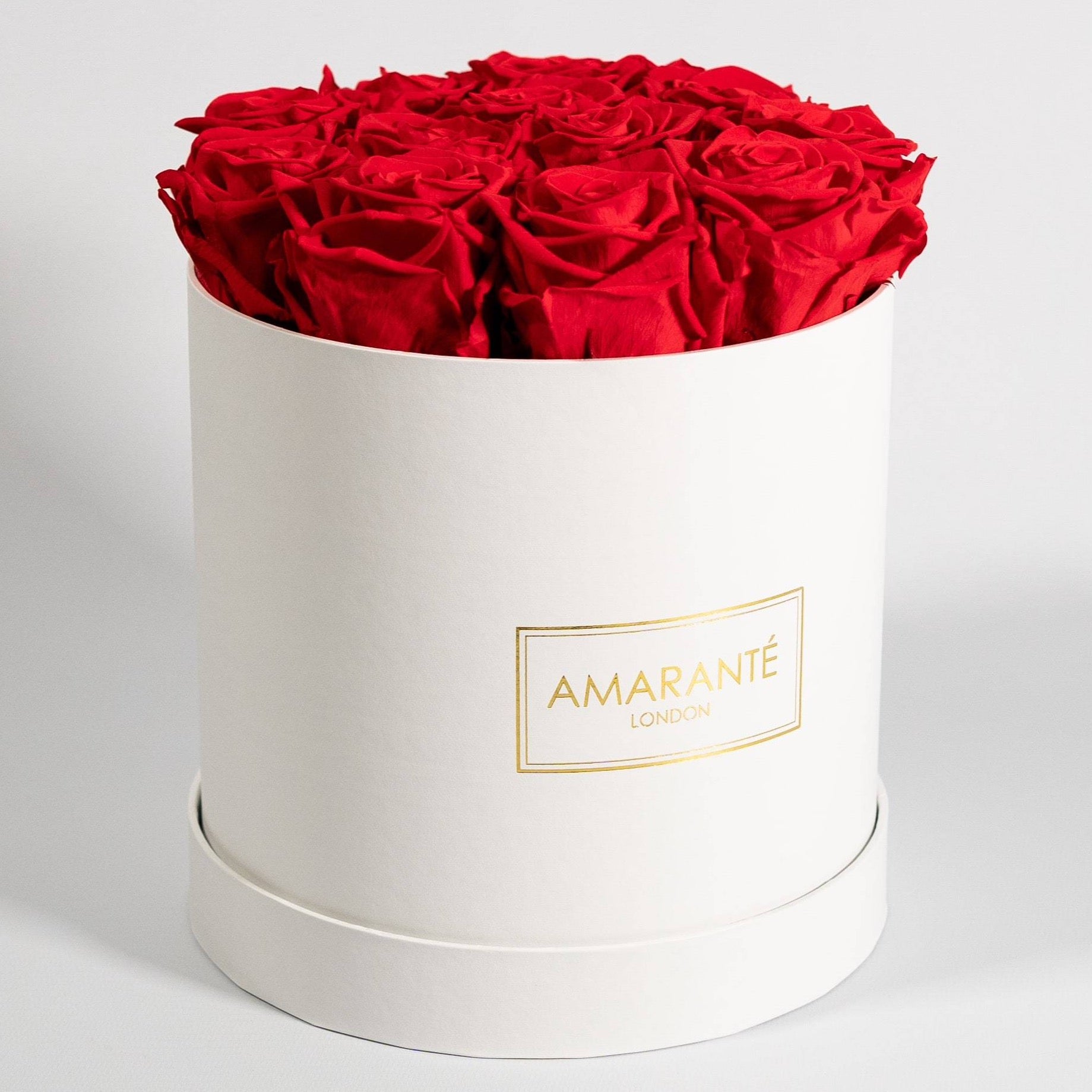 Divine red Roses featured in a dapper white box 