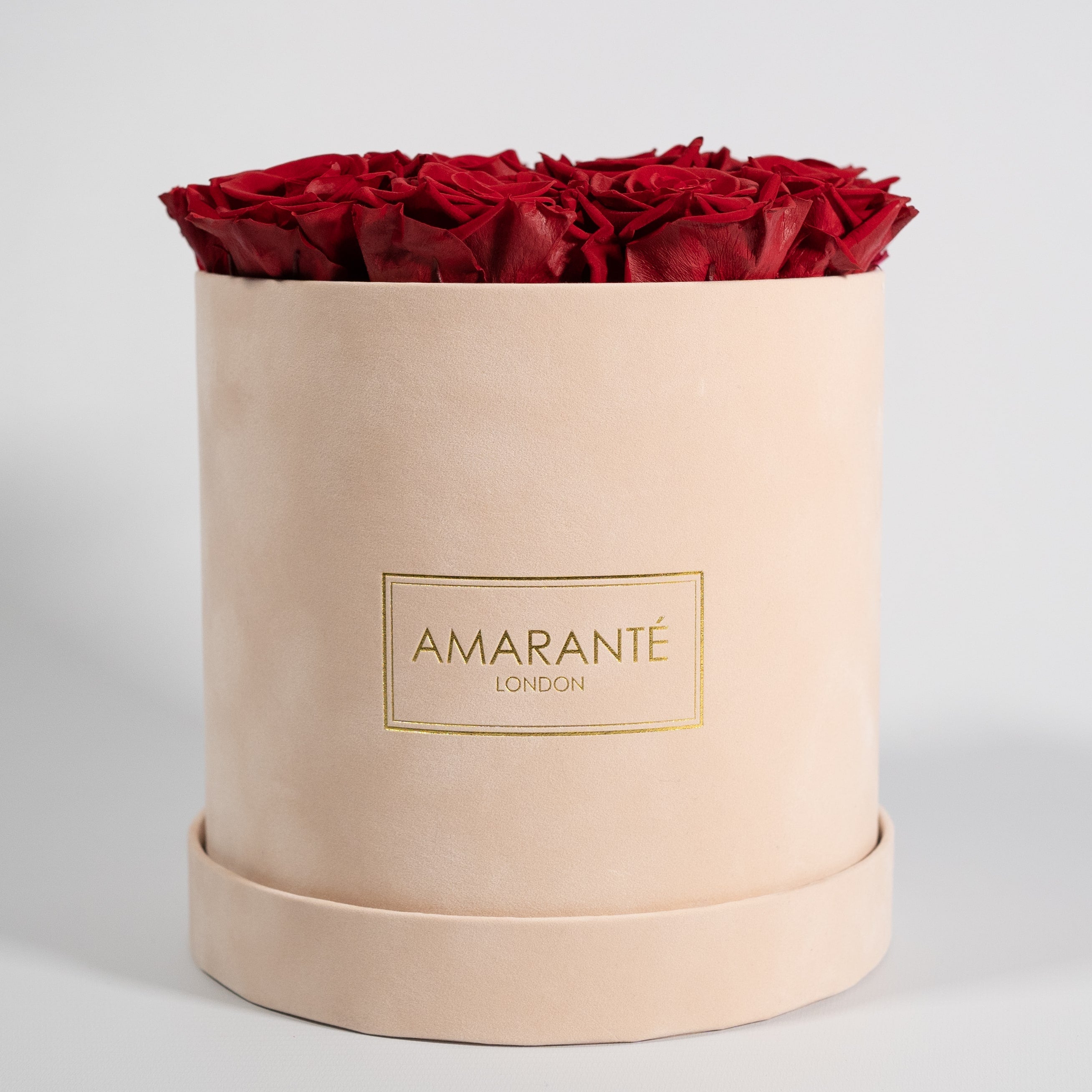 Chic wine red roses showcased in an elegant beige box. 