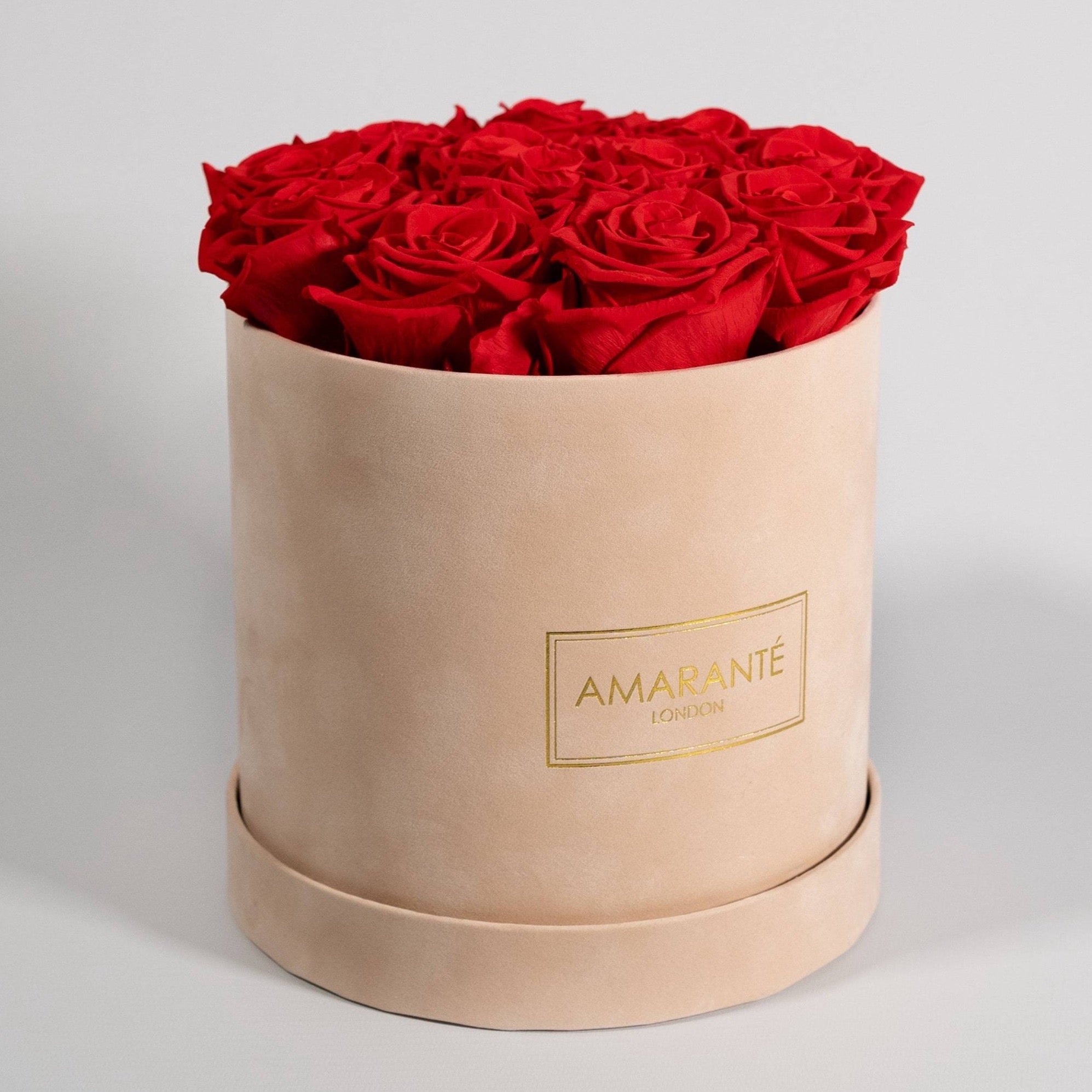 Majestic red roses in a blushing beige box. 