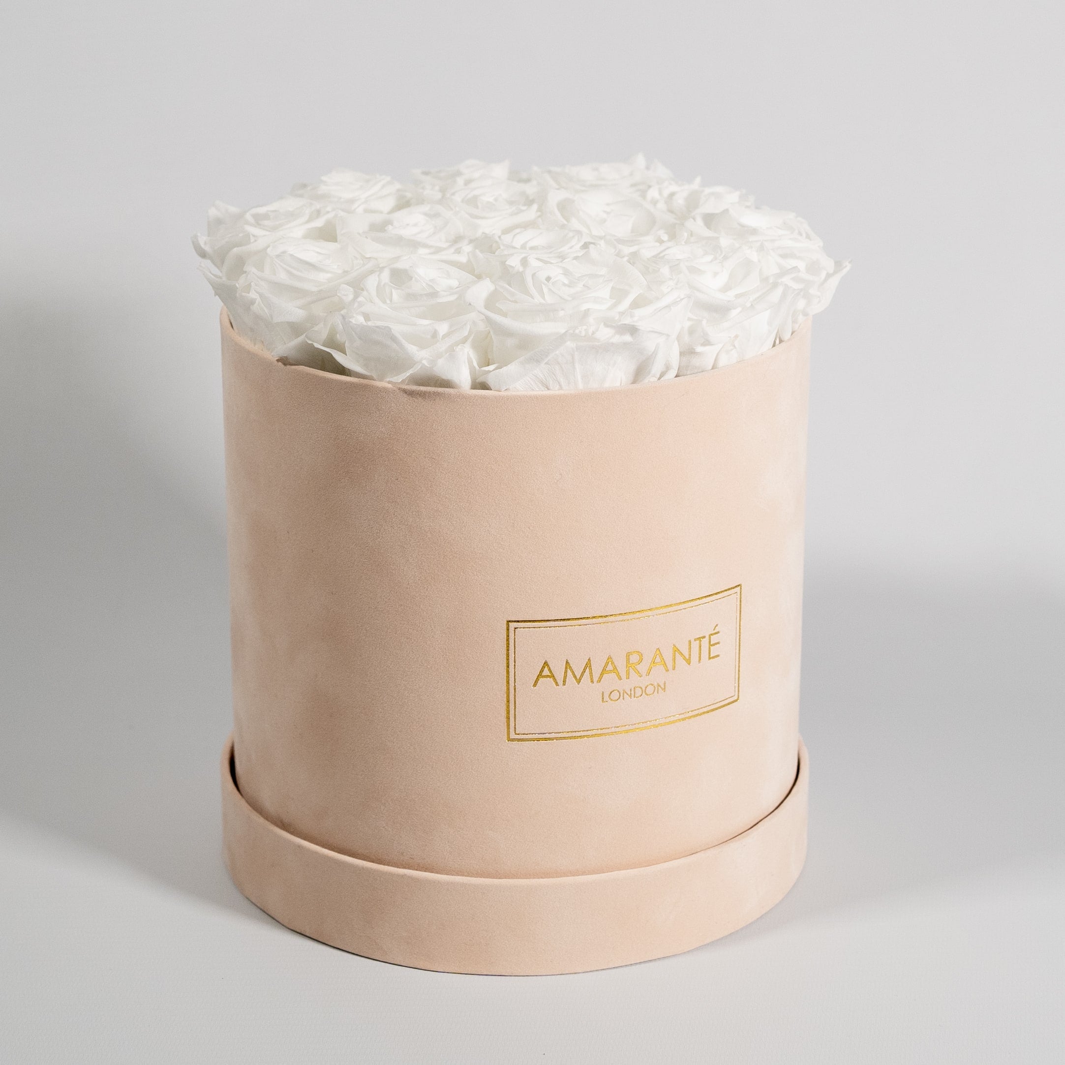 Heart-warming white roses exhibited in a stunning pink box. 