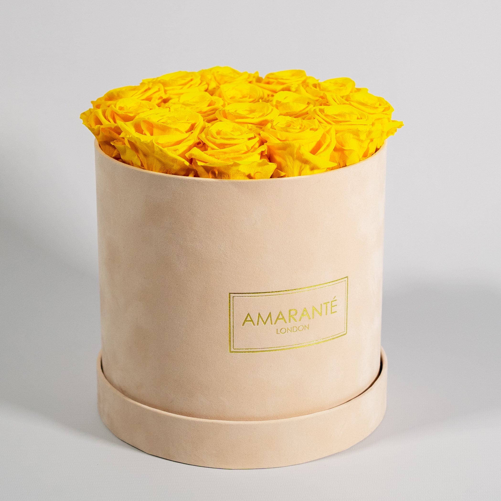 Abloom yellow roses presented in a chic beige medium box. 