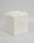 Enchanting white roses featured in a monochromatic white box 