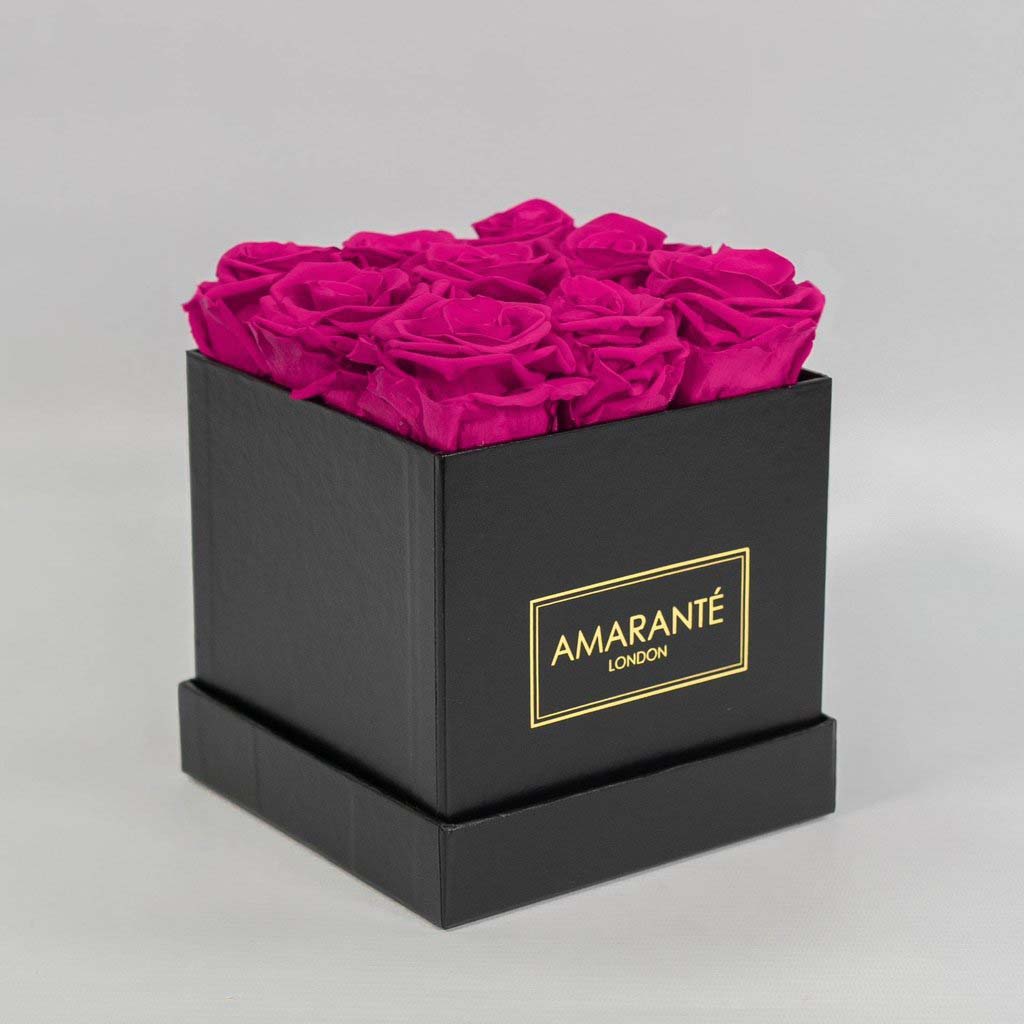 Expressive hot pink roses encompassed in a stylish black box 