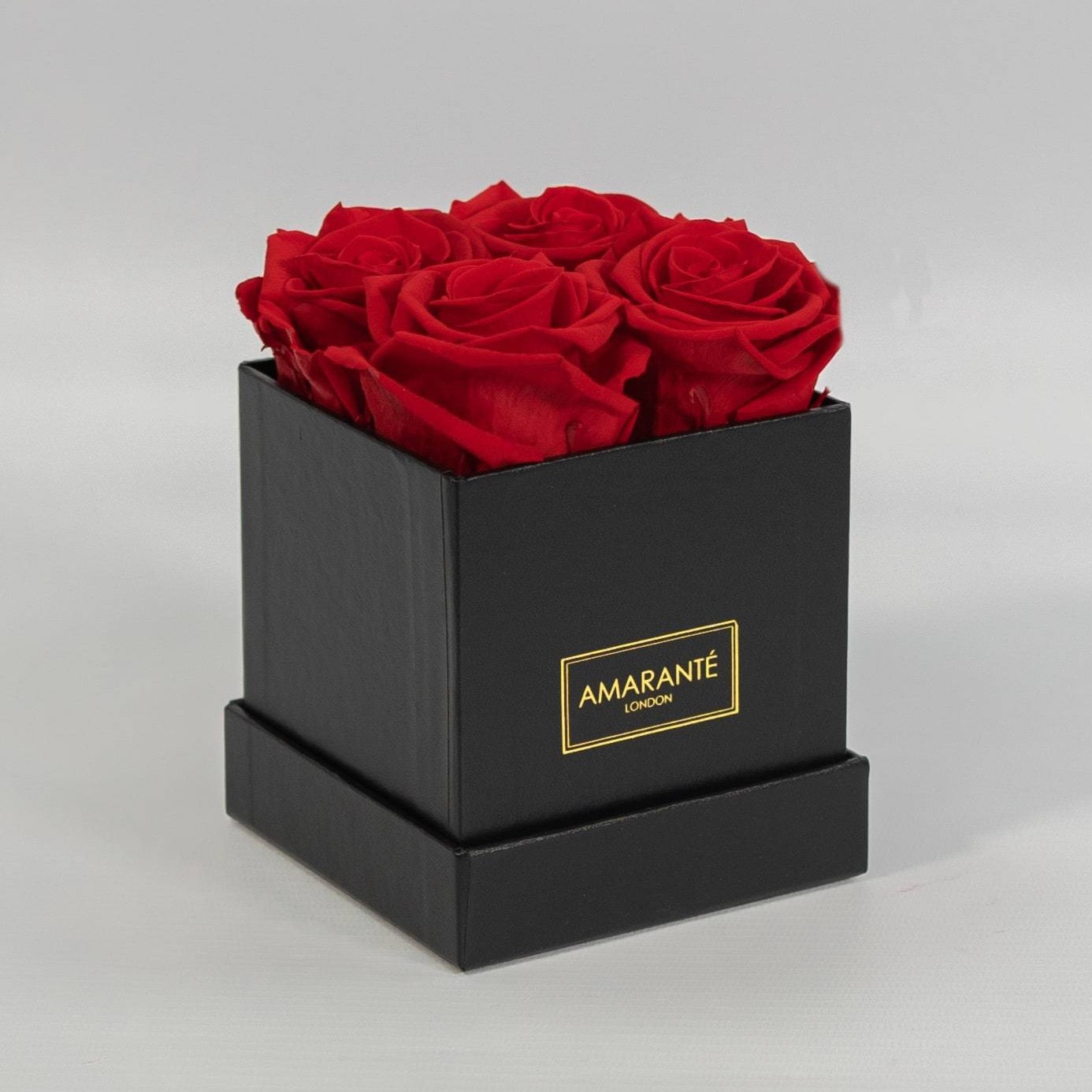 Aromatic red roses in a dapper black small square box 