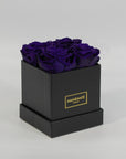 Magical dark purple roses encompassed in a stylish black box 