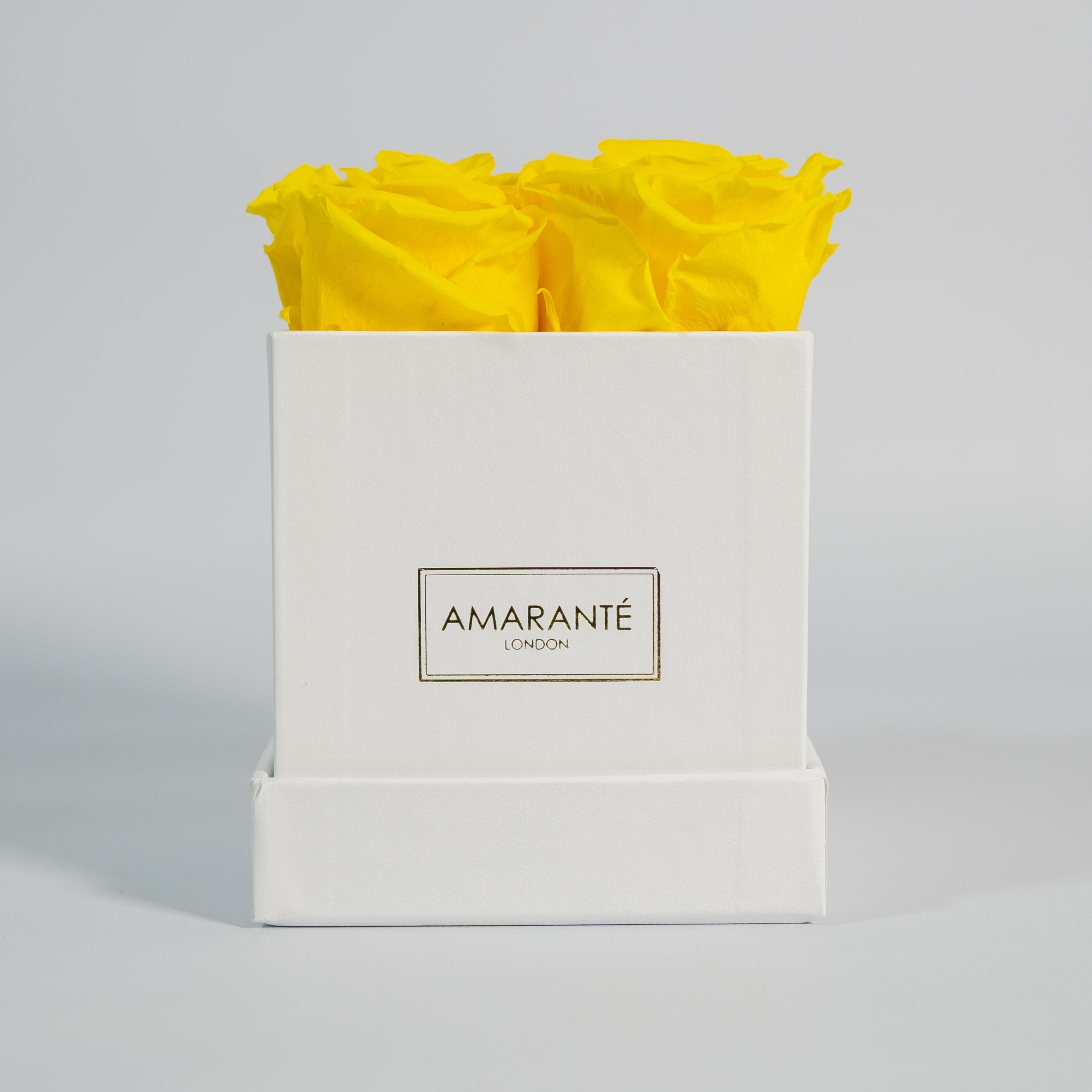 Delightful yellow roses shown in a magical white box