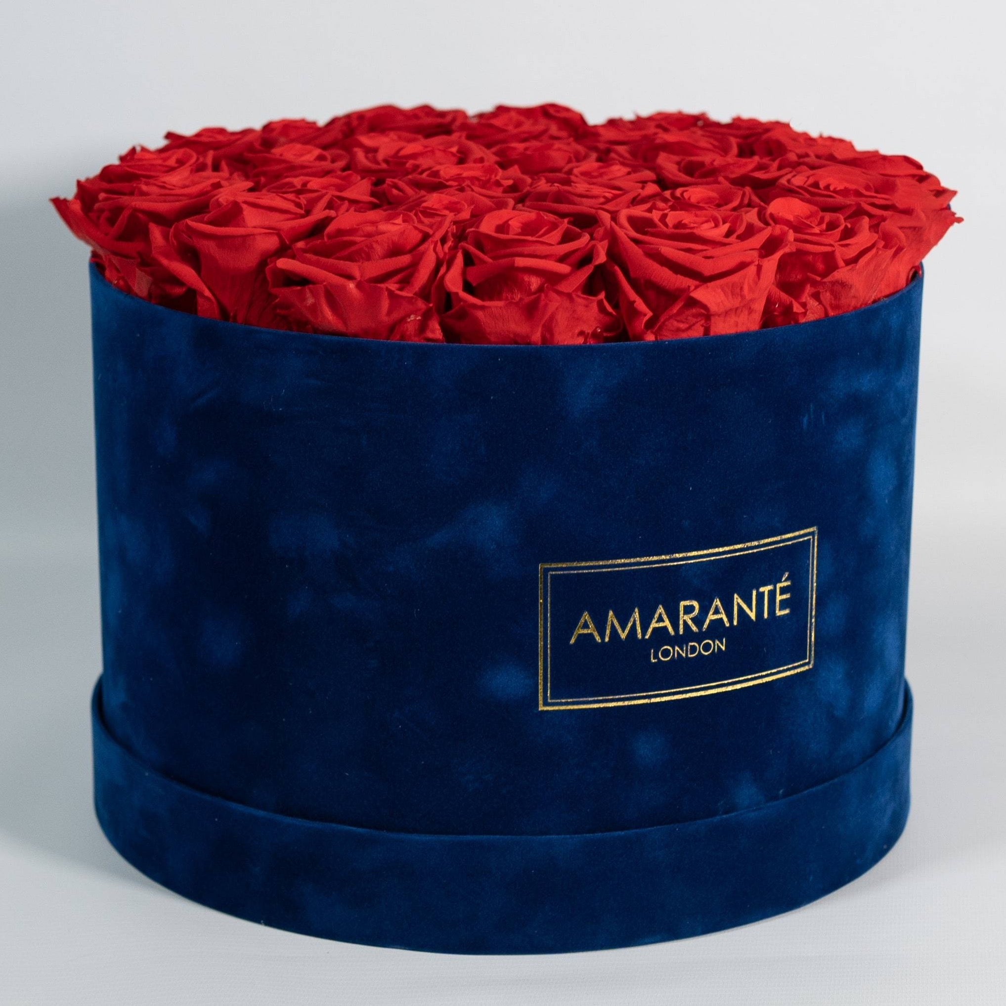 Elegant red Roses shown in a sophisticated extra large blue round box. 