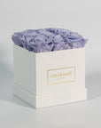 Artful lavender roses exhibited in a modish white box 