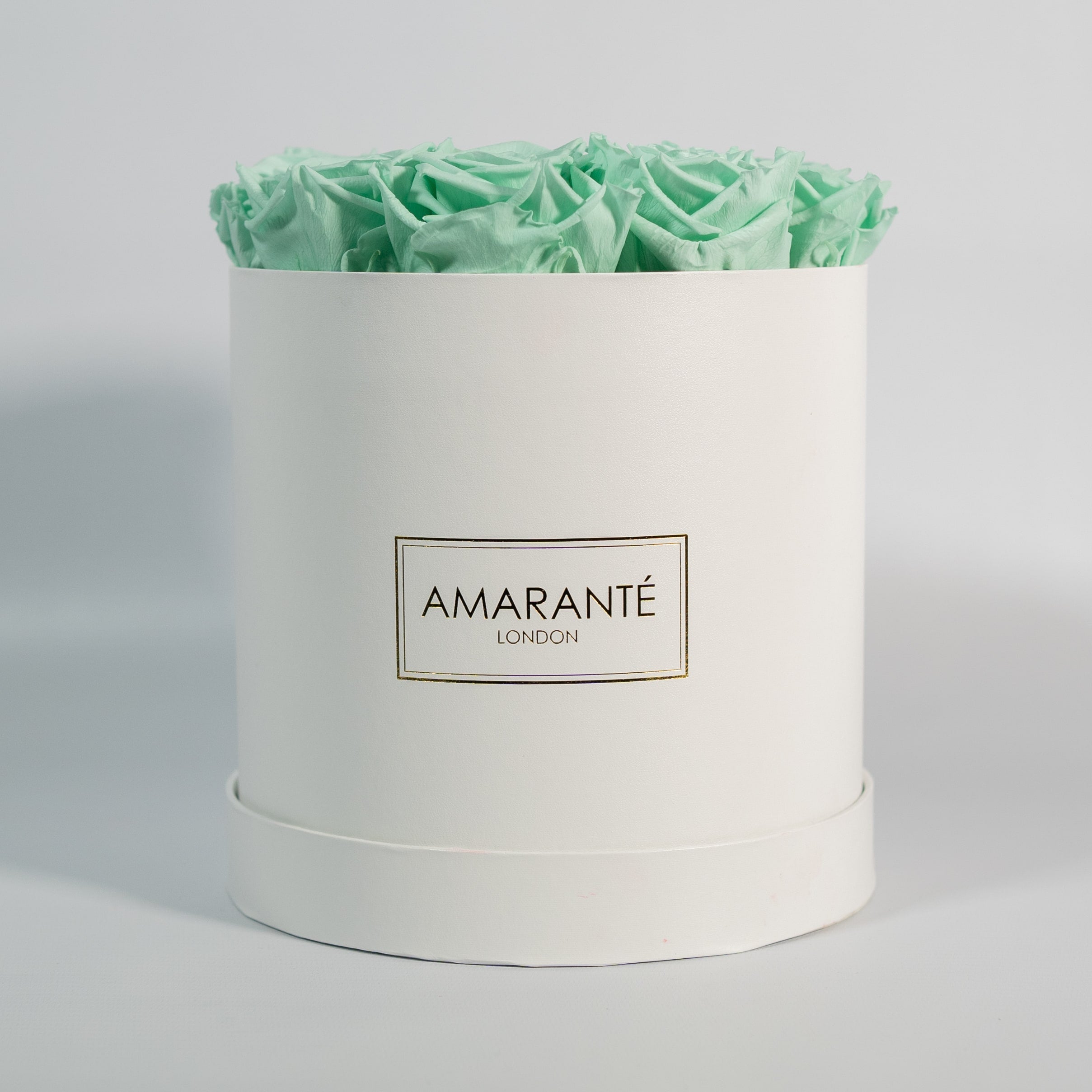 Enchanting mint green roses featured in a gorgeous white  medium box 