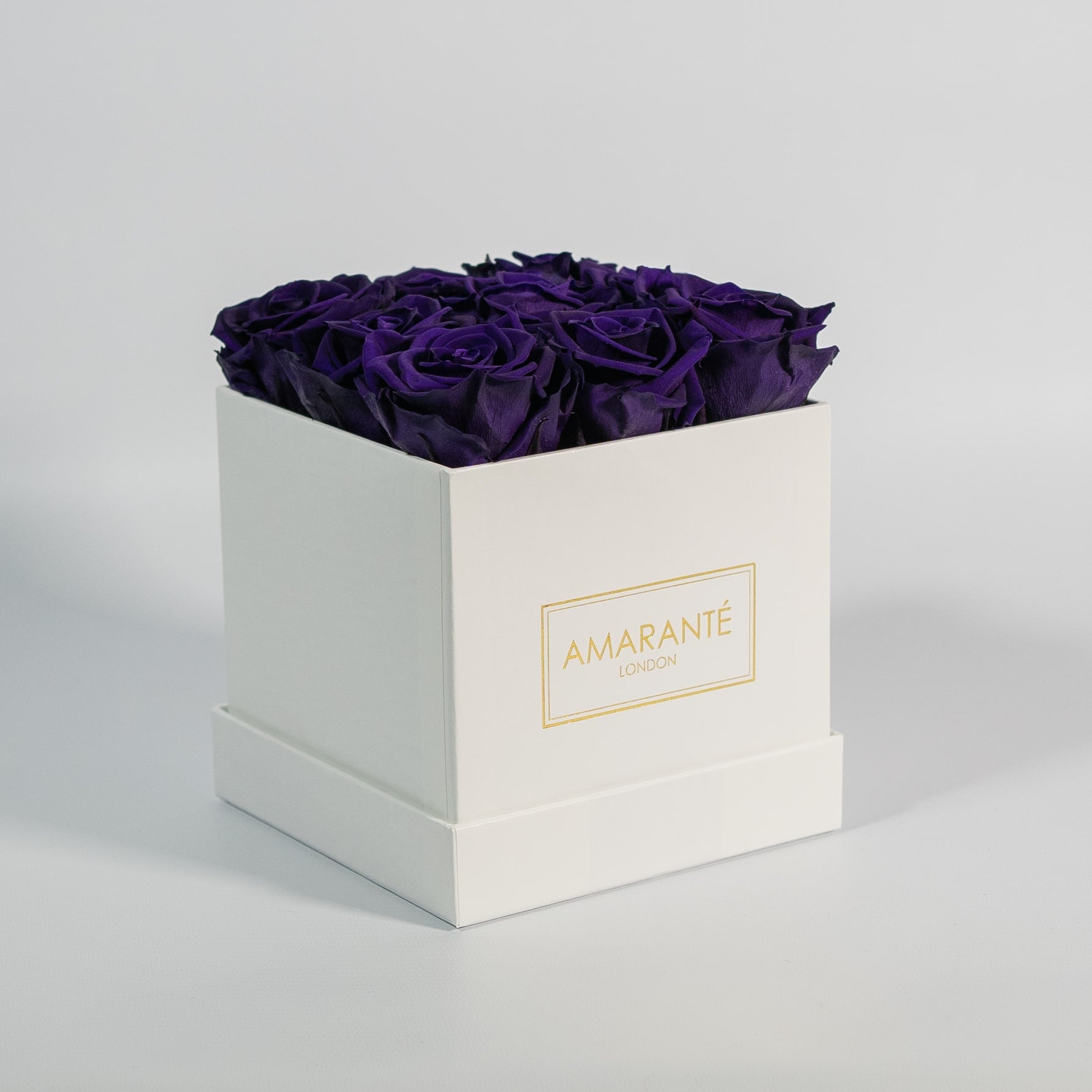 Luxurious dark purple roses included in  a stunning white box 