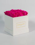 Distinctive hot pink roses photographed in a gorgeous white box 