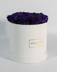 Luxurious dark purple roses entrenched in a beautiful white box 
