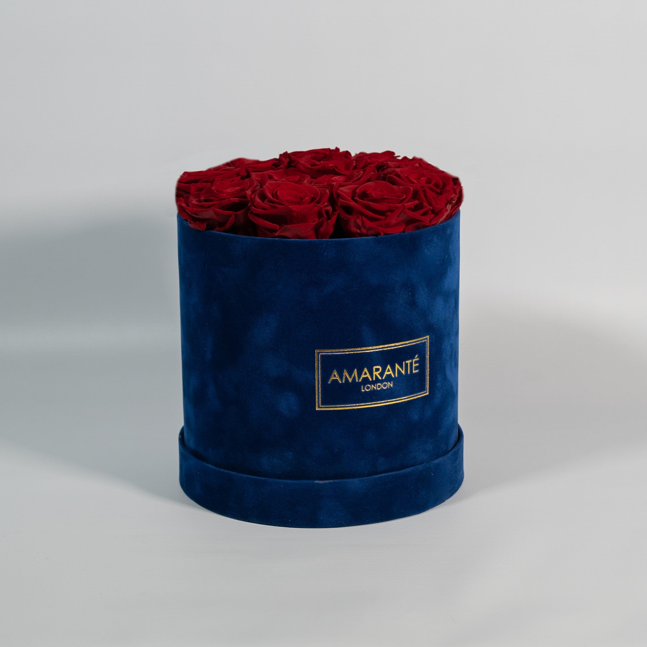 Chic wine red Roses displayed in a modish blue box 