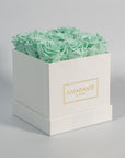 Elegant mint green roses presented in a fashionable white box 