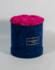 Expressive hot pink Roses shown in a beautiful blue box 