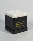 Captivating white roses entrenched in a modish black box 