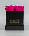 Distinctive hot pink roses shown in a stylish black box  