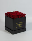 Divine wine red roses photographed in a sleek black box 