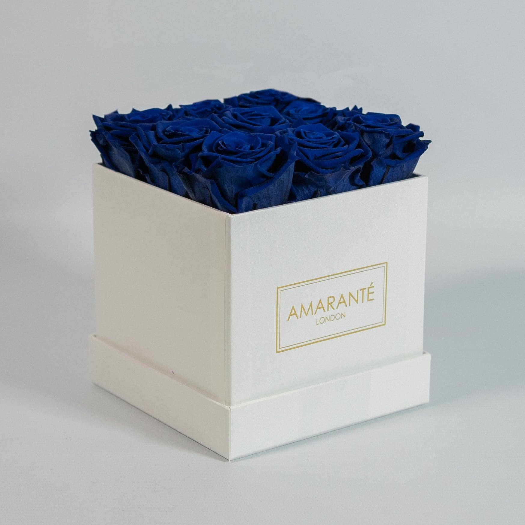 Luxurious royal blue roses indicated in a sophisticated white box 