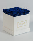 Luxurious royal blue roses indicated in a sophisticated white box 