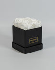 Captivating white roses placed in a vogueish black box 